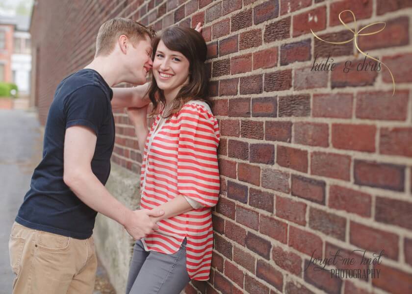 Columbus Ohio Engagement couple leaning on brick wall