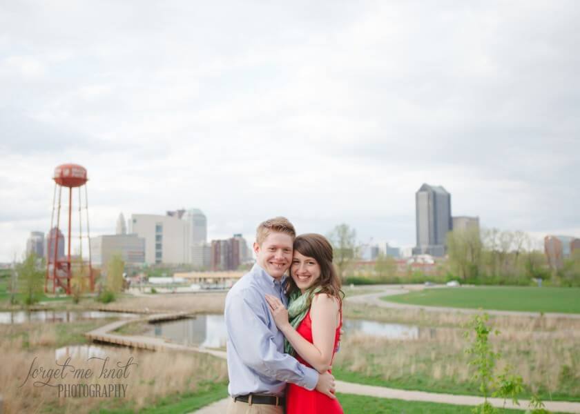 engaged couple at Columbus Ohio Engagement with columbus skyline in back