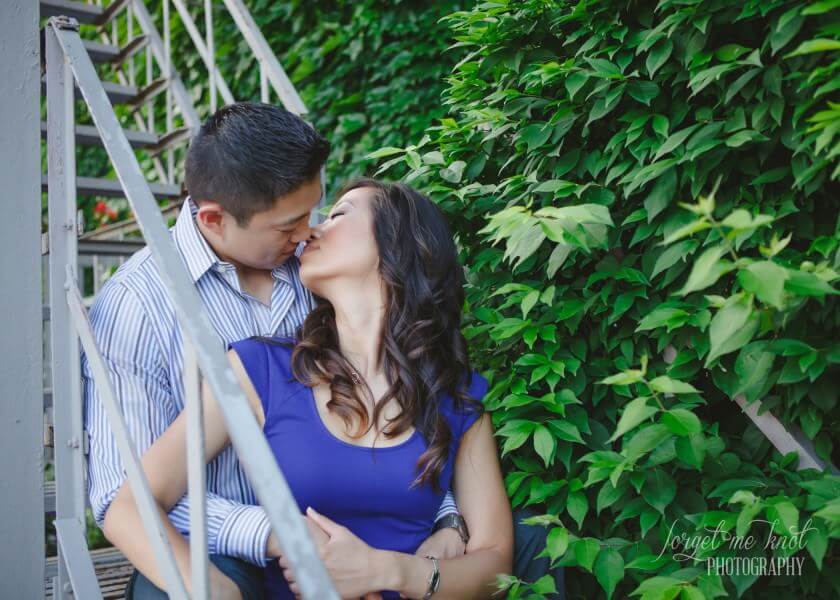 engaged couple sitting on steps kissing at columbus ohio photography engagement