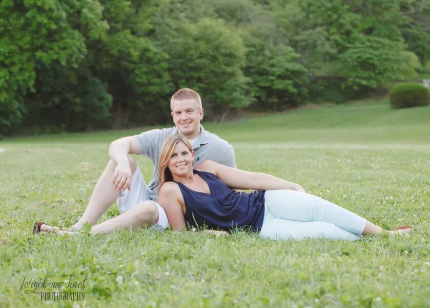 engaged couple laying in grass at Eden Park Engagement