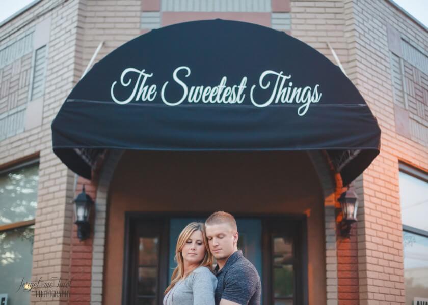 engaged couple in front of the sweetest things in cincinnati