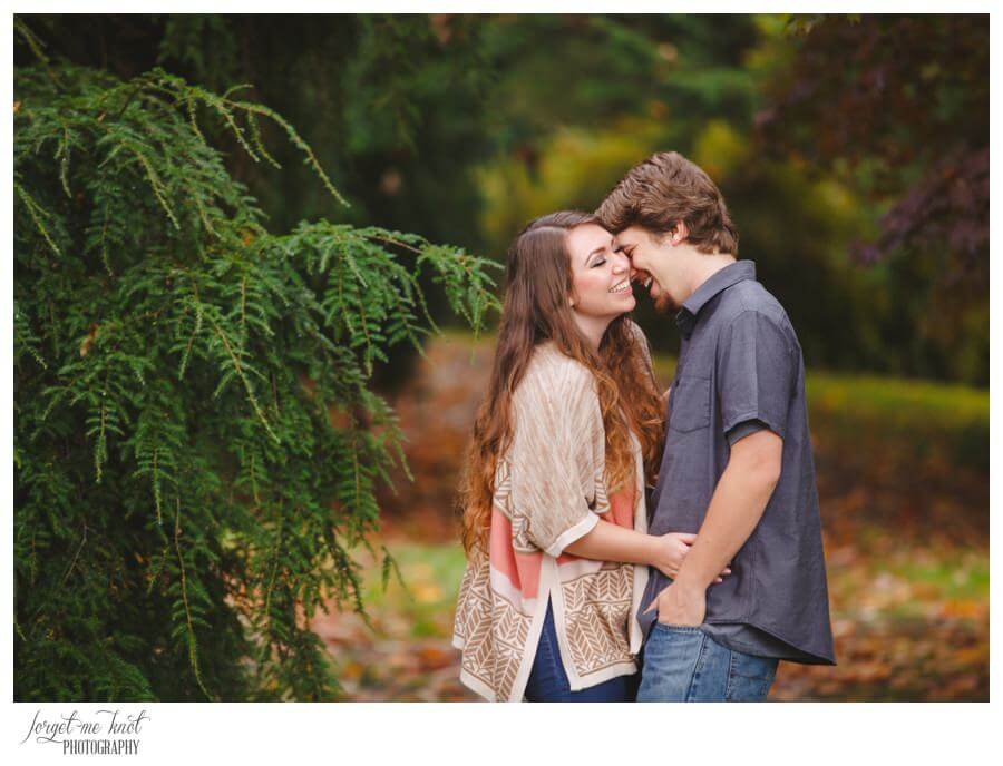 engaged couple hugging and laughing at Dawes Arboretum