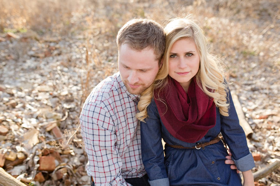engagement photo of couple sitting on tree