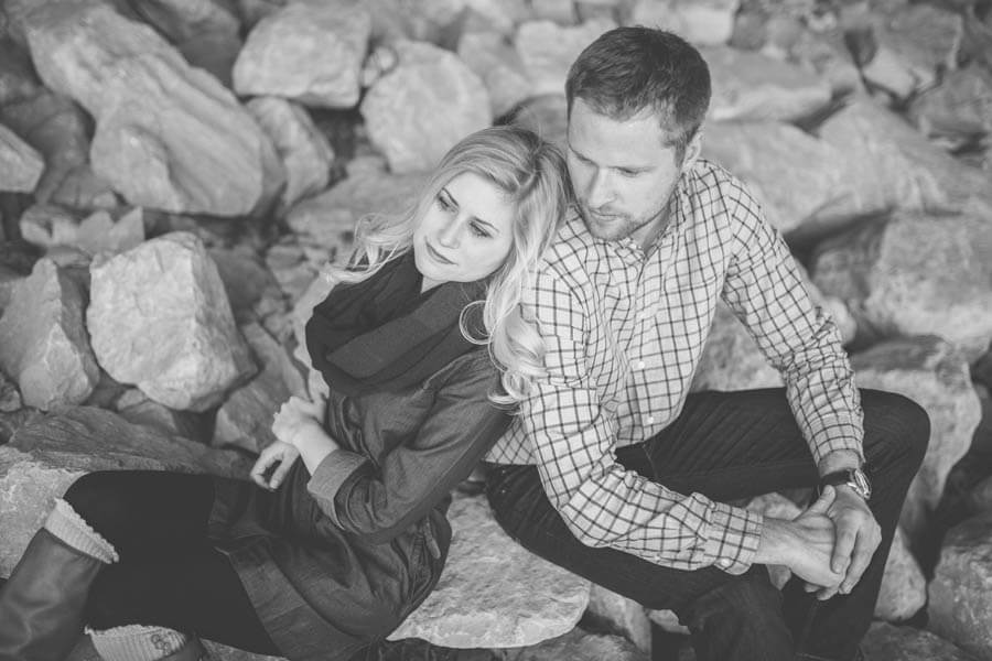 engagement photo of couple under overpass cuddling