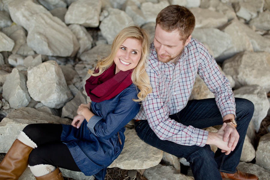 engagement photo of couple smiling under overpass in short north