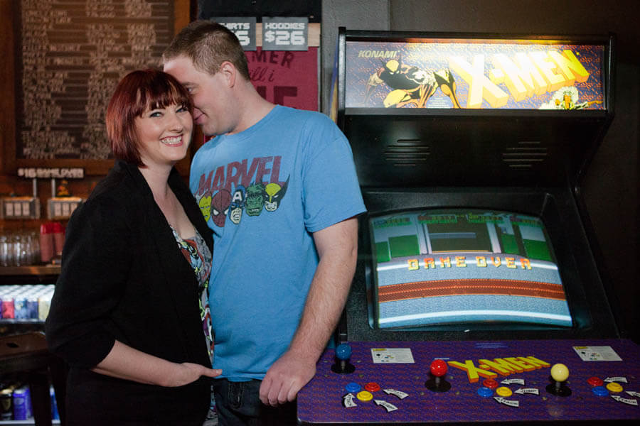 engagement photo of couple at 16-Bit Bar & Arcade