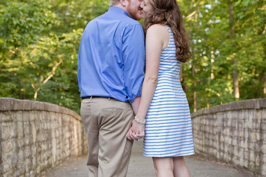 photo of engaged couple kissing while holding hands Inniswood Metro Park