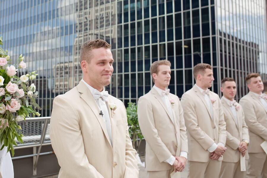 grooms first look of bride walking down aisle at the renaissance columbus