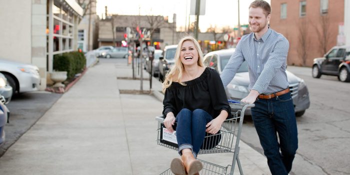 engaged couple in grocery cart