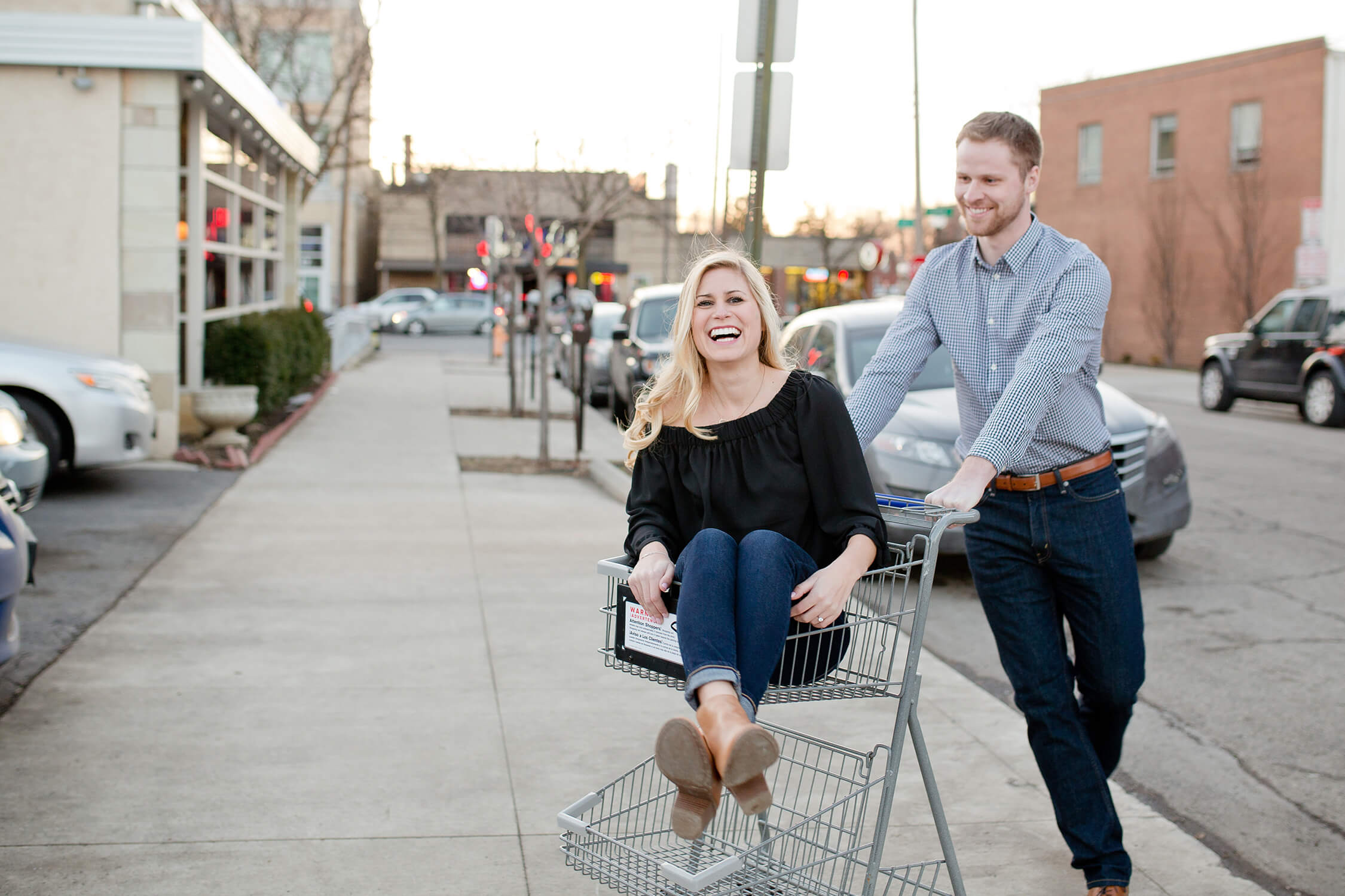 engaged couple in grocery cart