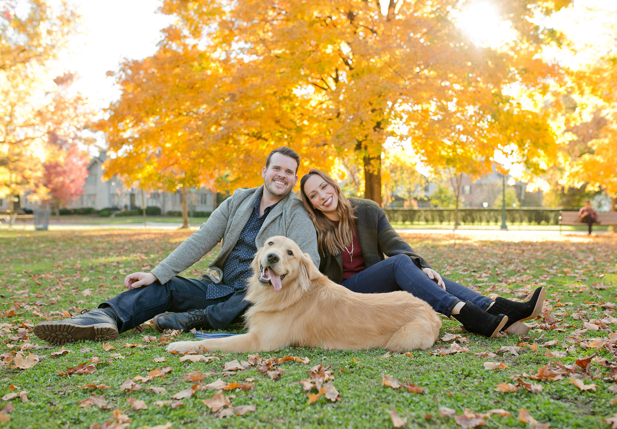 engaged couple in park with dog