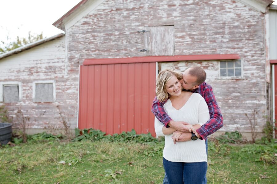 engaged couple with arms around each other at columbus ohio farm
