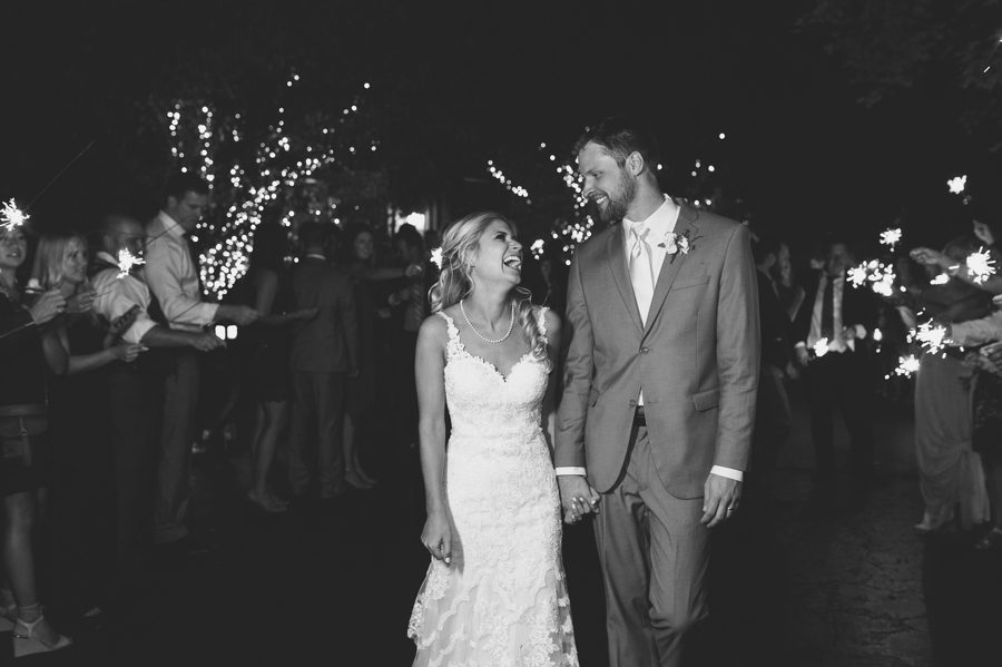 bride and groom laughing during sparkler exit