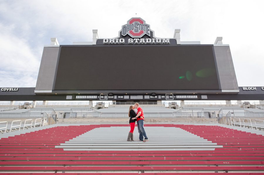 engaged couple kissing at Ohio State University stadium