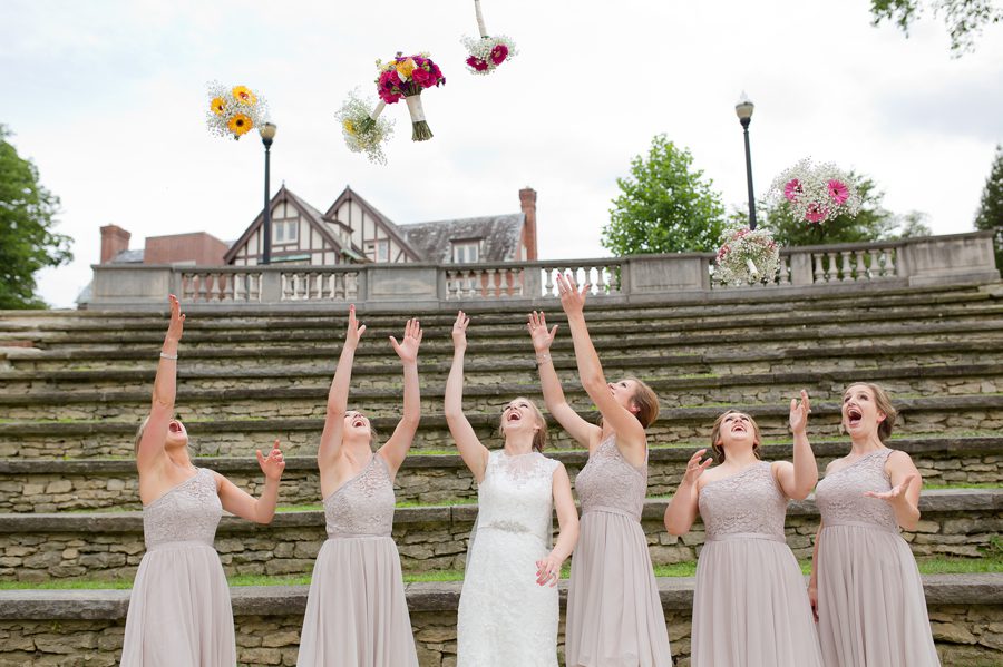bride and bridesmaids tossing bouquets