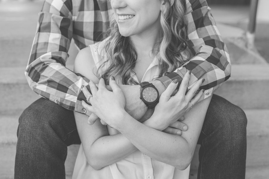 engaged couple with arms wrapped around each other