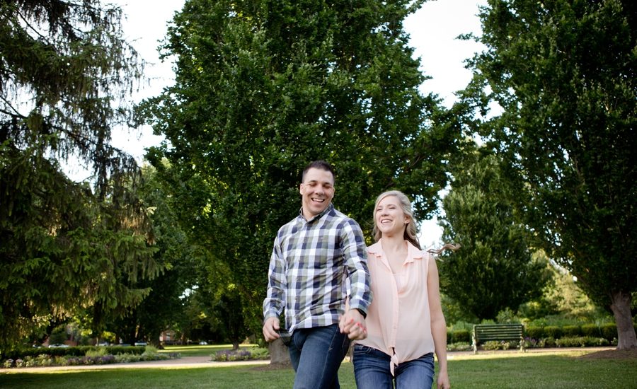 engaged couple running at Schiller Park