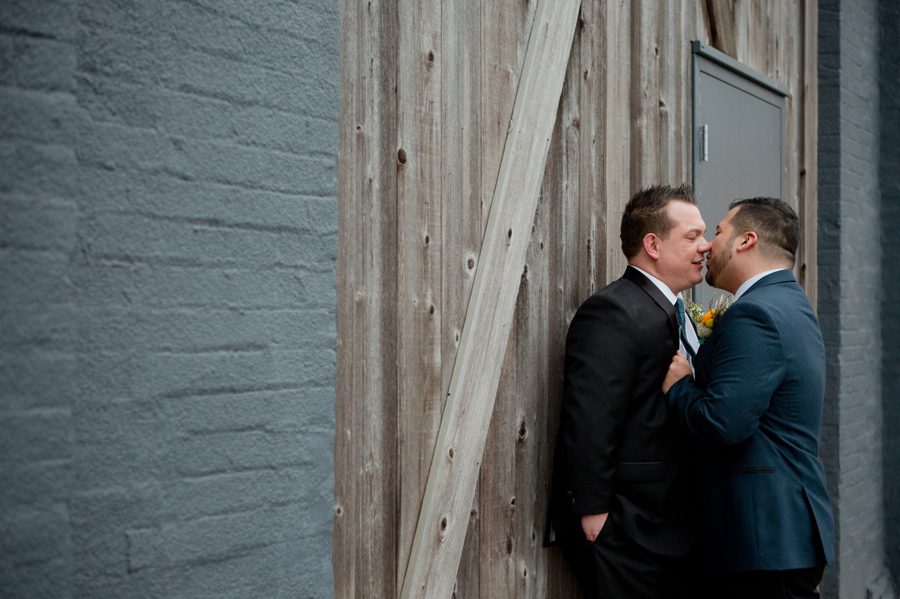 same sex couple kissing outside of High Line Car House