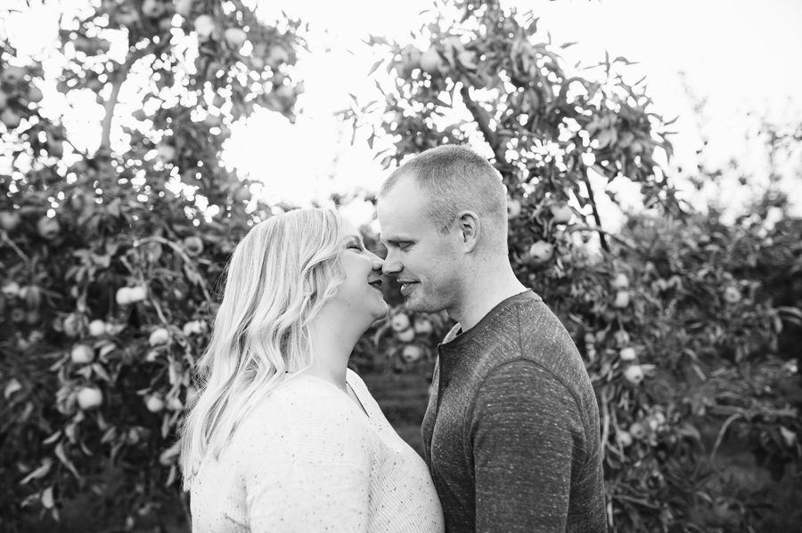 engaged couple being intimate at apple orchard Lynd's Fruit Farm 