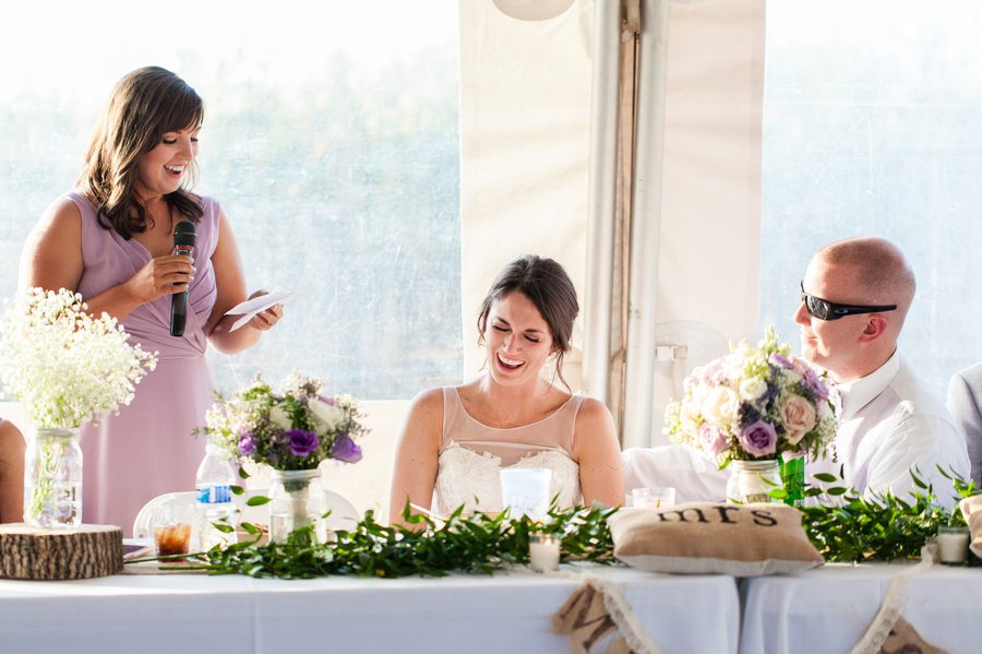 bride laughing at maid of honor speech