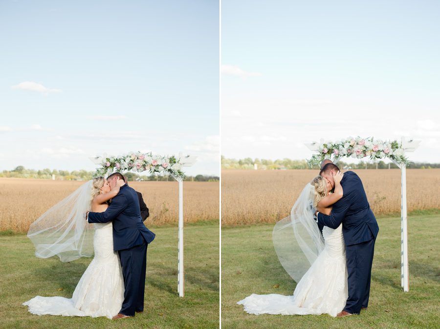 bride and groom first kiss at a barn wedding in ohio