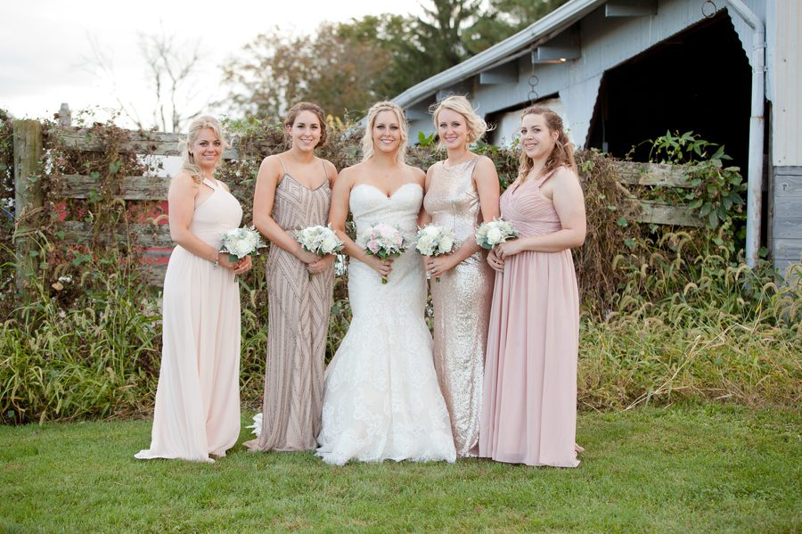 bride with bridemaids with different colors of blush dresses