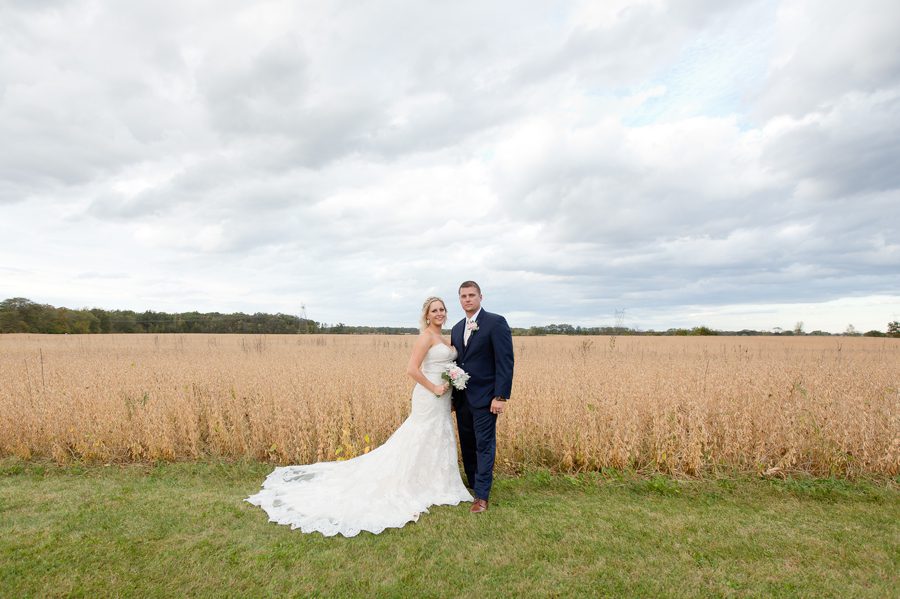 wide photo of a bride and groom in a field at a barn wedding in ohio