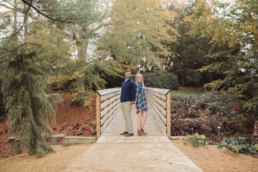 engaged couple standing back to back at Dawes Arboretum Engagement