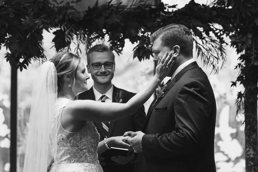 bride wiping grooms tears at grange insurance audubon center wedding