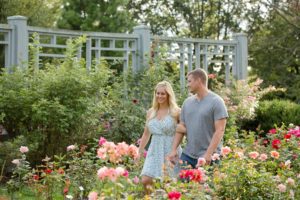 engaged couple walking in rose path at Inniswood Metro Gardens