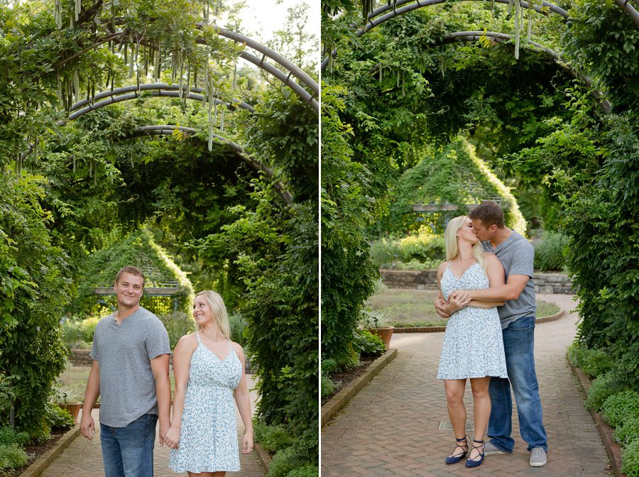 engaged couple kissing under wisteria vines
