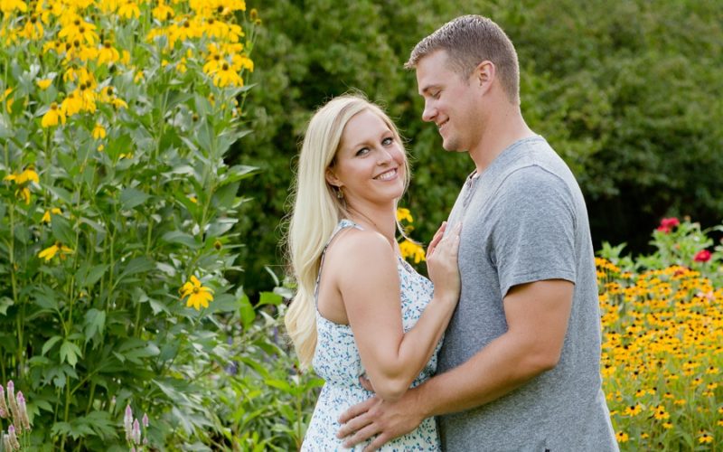 engaged couple in front of black eyed susans