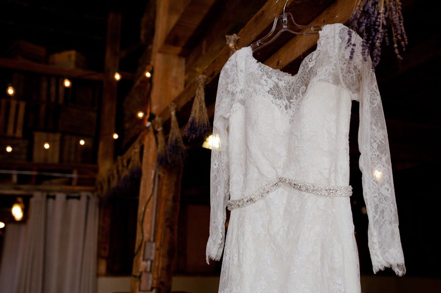 wedding dress hanging inside jorgensen farm barn
