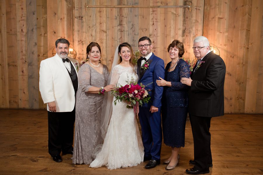 bride and groom with parents at jorgensen farm wedding
