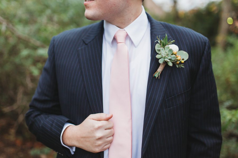 close up of grooms pink tie and navy pin striped suit