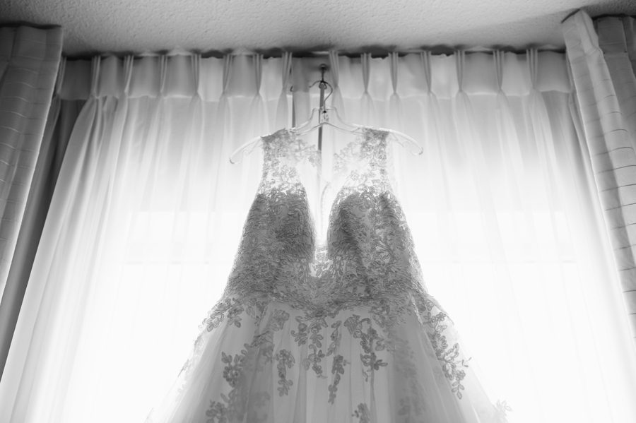 black and white photo of wedding dress hanging