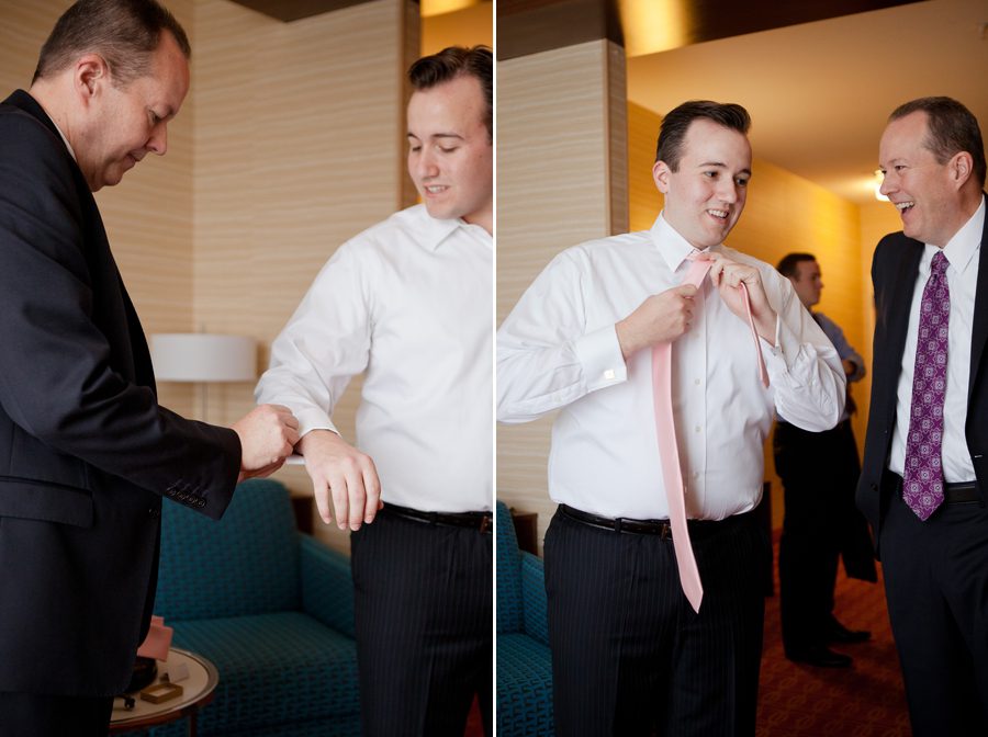 groom tying tie for wedding