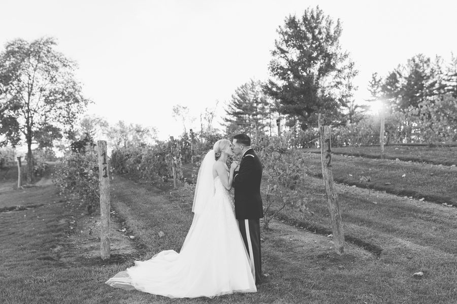 black and white photo of couple kissing in middle of vineyard at The Corazon Dublin Ohio