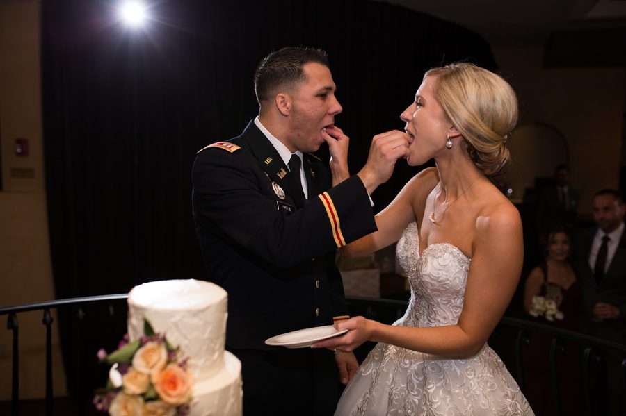 bride and groom feeding each other wedding cake