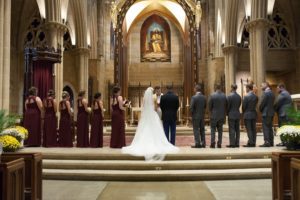 wedding party standing at alter in church
