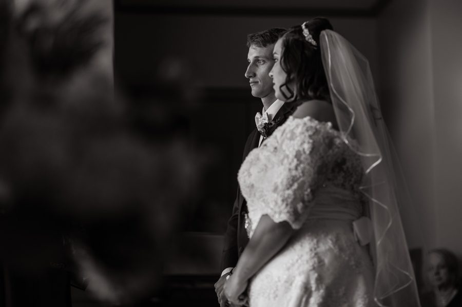 black and white photo of bride and groom at ceremony