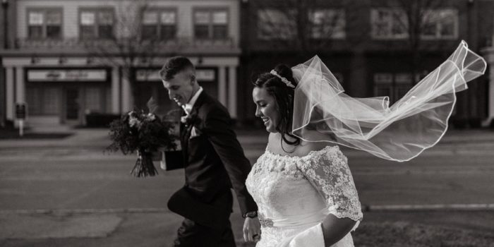 black and white photo of brides veil blowing
