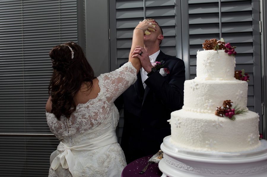 bride shoving cake in grooms face