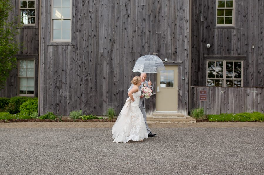 bride and groom walking in rain