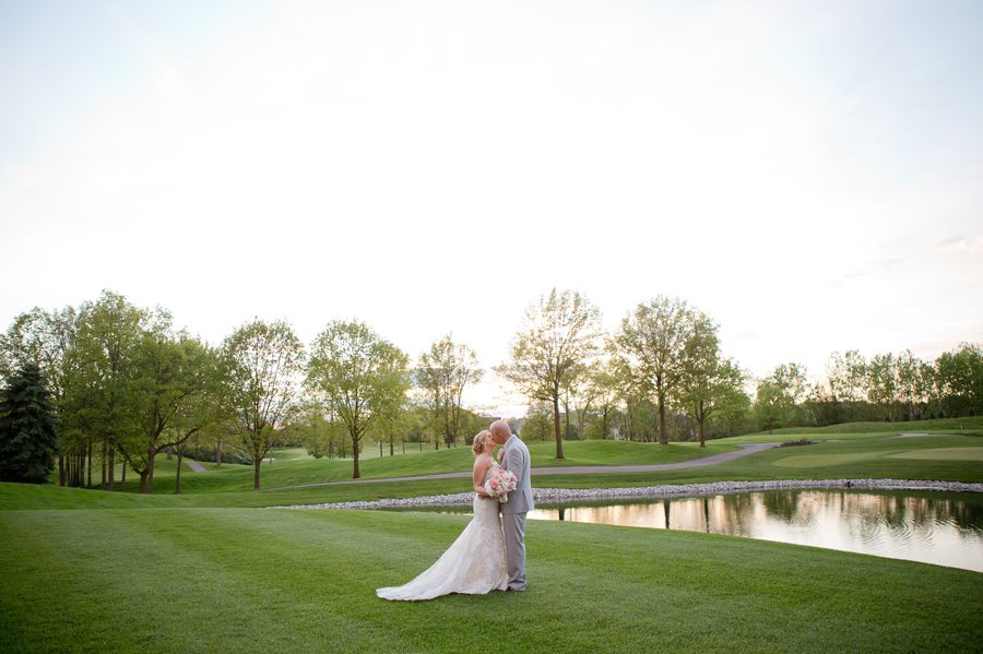 couple kissing by water at wedgewood country club