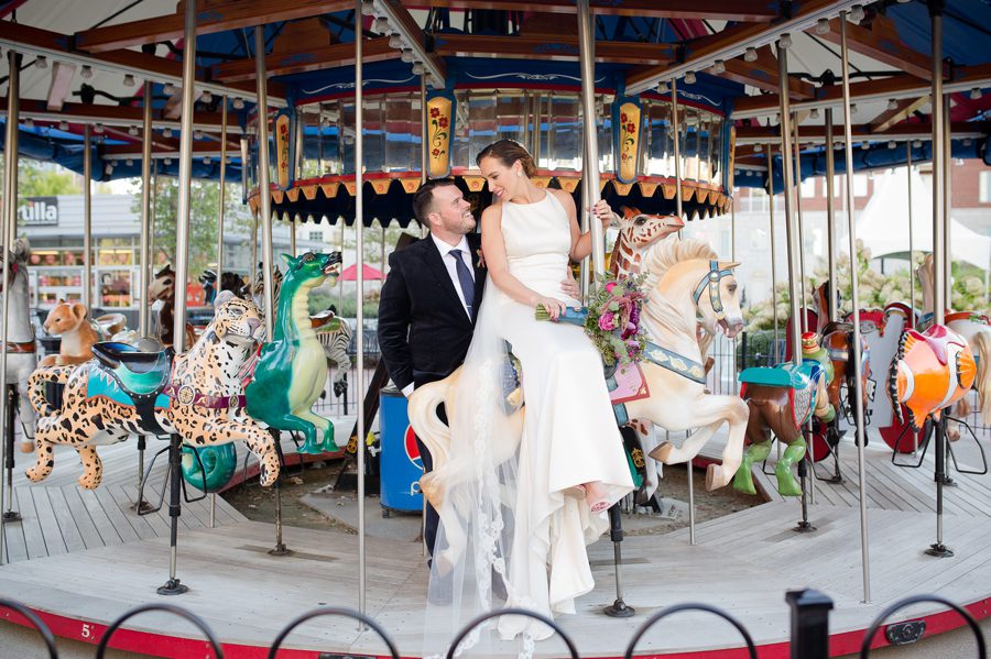 bride and groom looking at each other on carousel