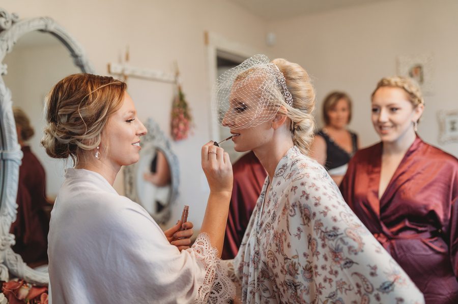 bride getting makeup touched up