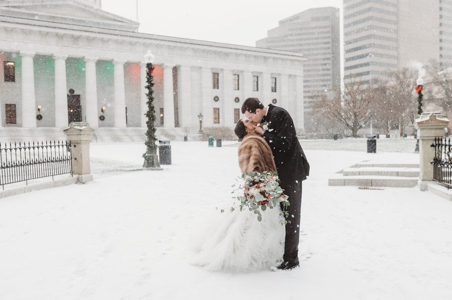 groom kissing bride at Ohio Statehouse for The Vault wedding