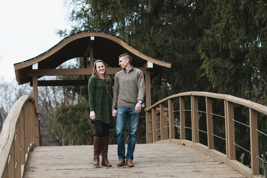 engaged couple on bridge at franklin park conservatory