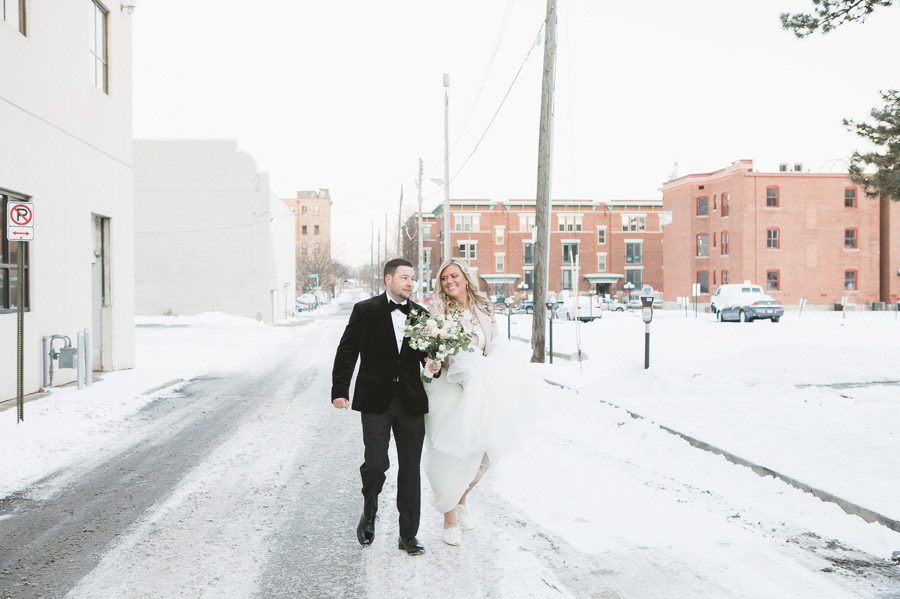 married couple walking in snowy road